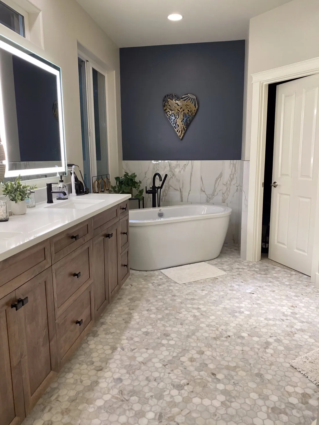 Black and gold clawfoot tub on penny tile in a Bellingham, WA bathroom remodel