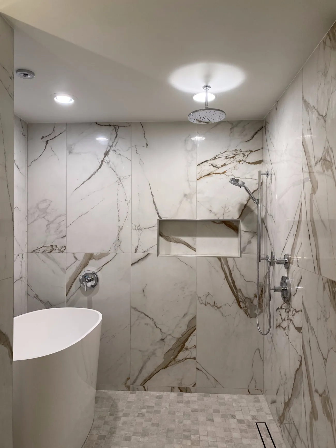 Marble walk-in shower with soaking tub in a Bellingham, WA bathroom remodel