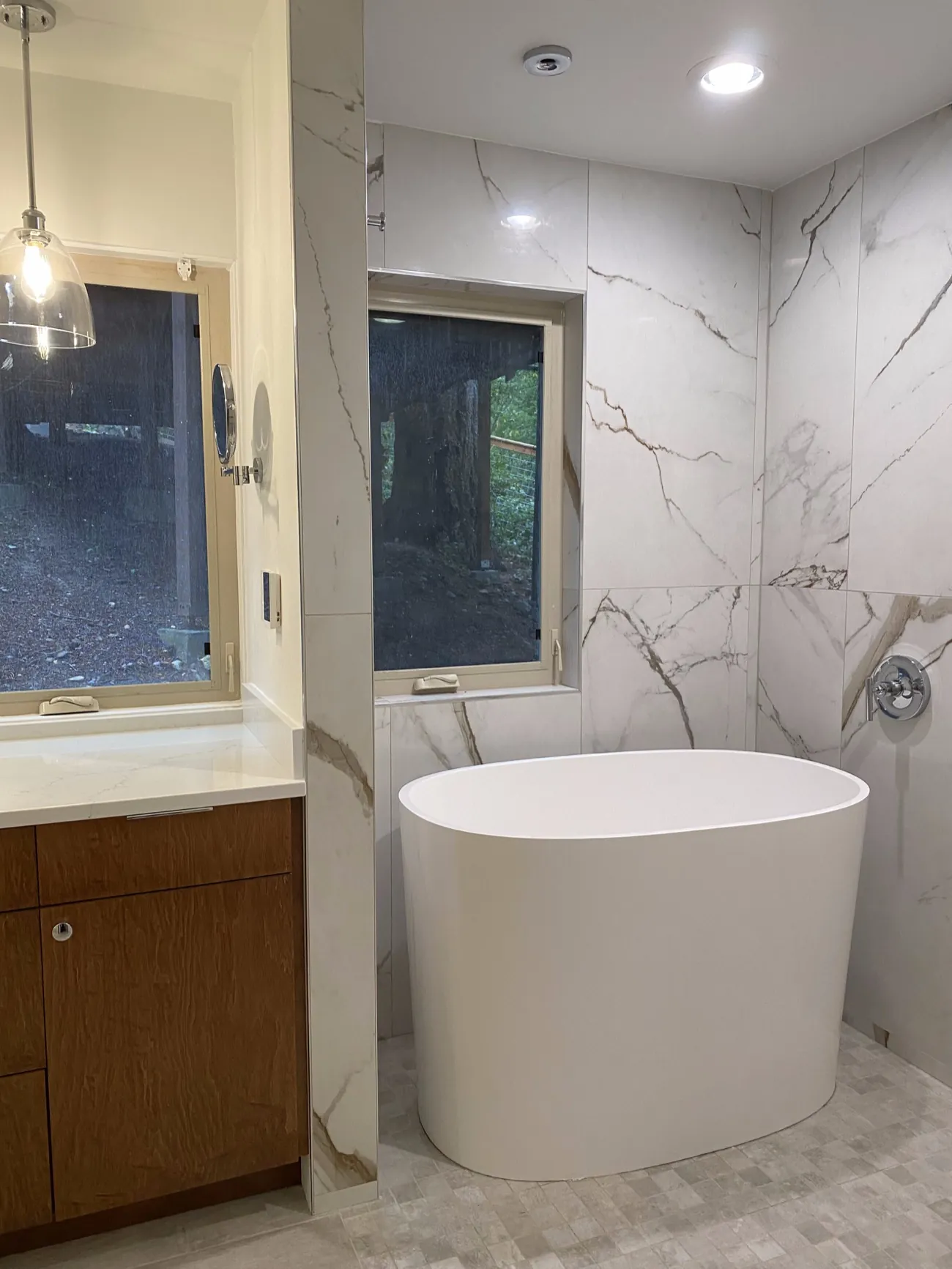 Bathroom remodel with freestanding soaking tub and marble tile in Bellingham, WA
